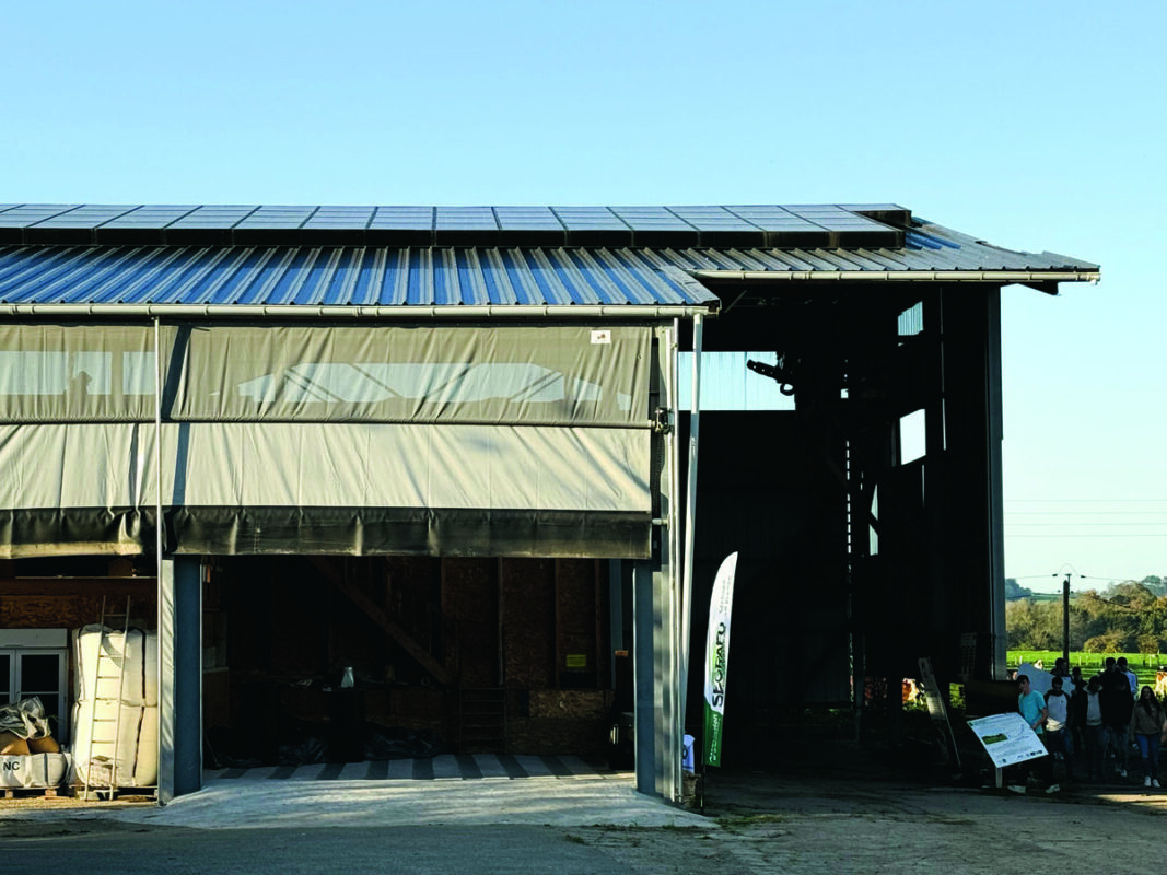 Un bâtiment agricole de séchage en grange dont la toiture est équipée de panneaux photovoltaïques.