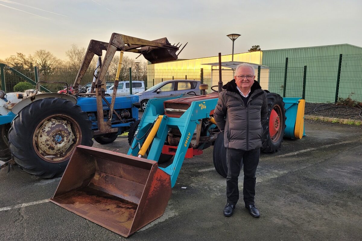 Michel Emily devant des tracteurs - Illustration 50 ans de solutions dédiées aux éleveurs